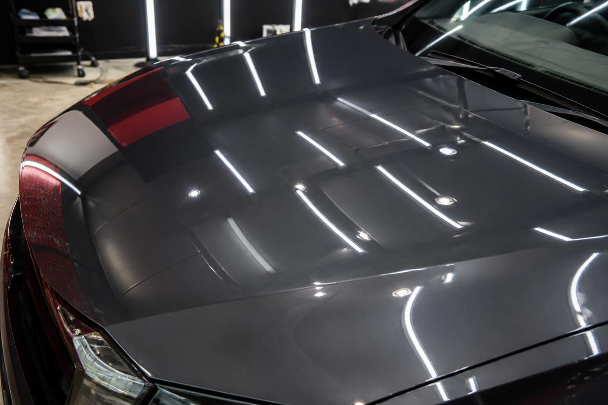 Mirror gloss car hood after two-stage paint correction by Apex Auto Detailing
