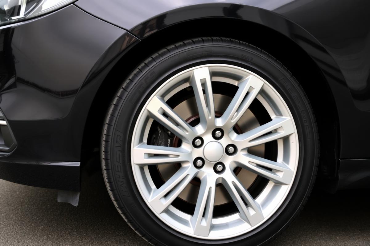 Spotless polished alloy wheel and glossy paint after exterior detailing